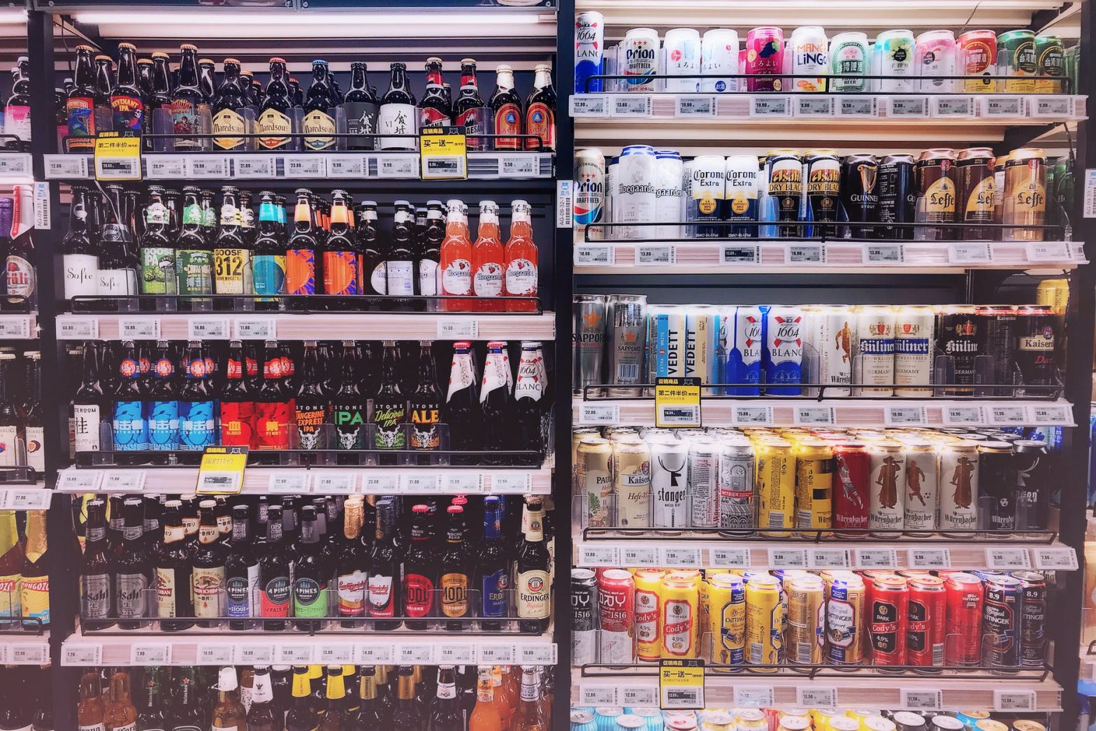 assorted bottles and cans in commercial coolers